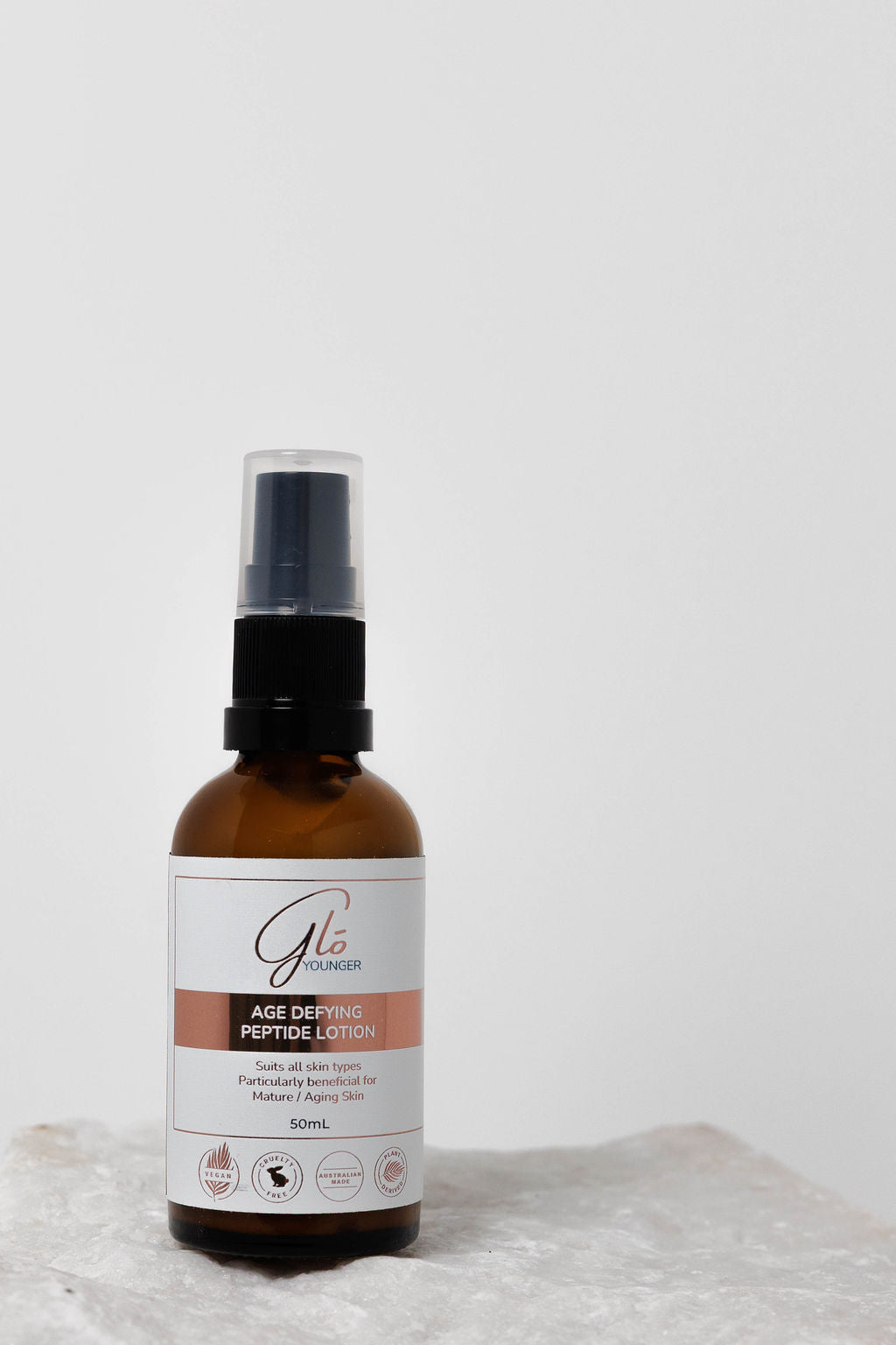 Glo Younger Age Defying Peptide Lotion bottle on stone
