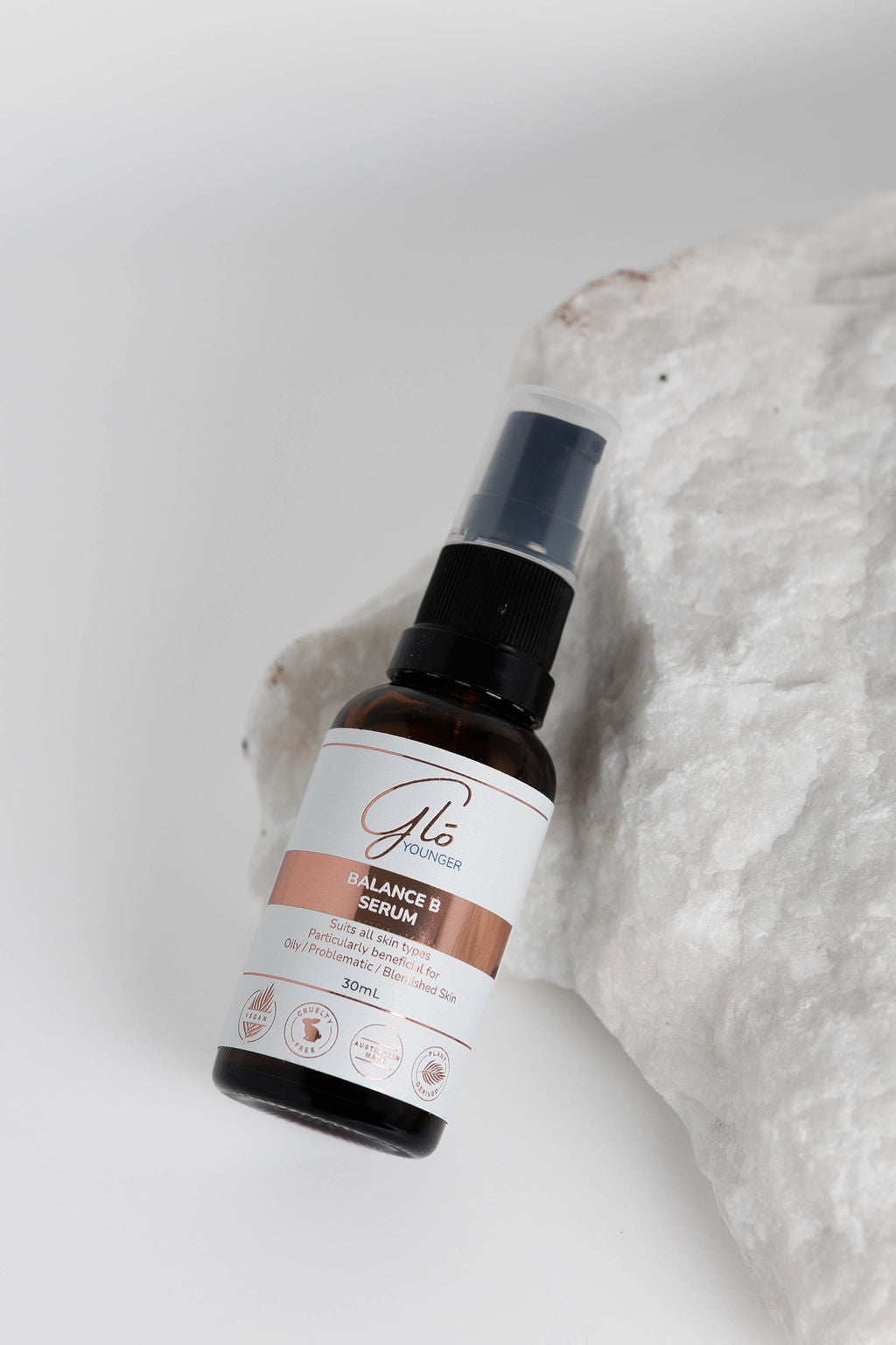 Glo Younger Balance B Serum bottle on stone