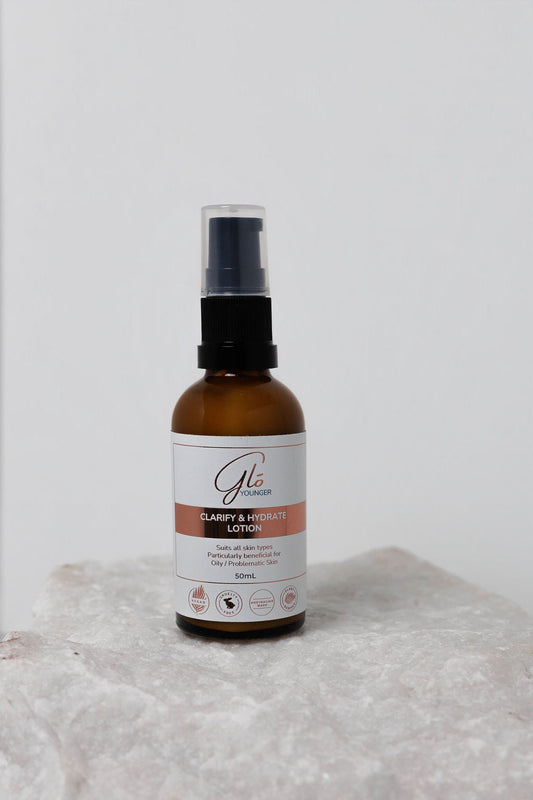 Glo Younger Clarify and Hydrate Lotion bottle on stone