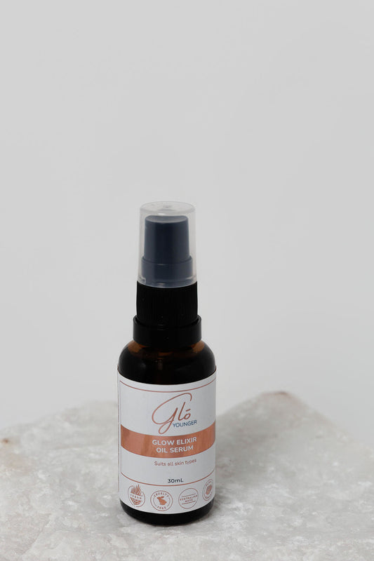 Glo Younger Glow Elixir Oil Serum bottle on stone