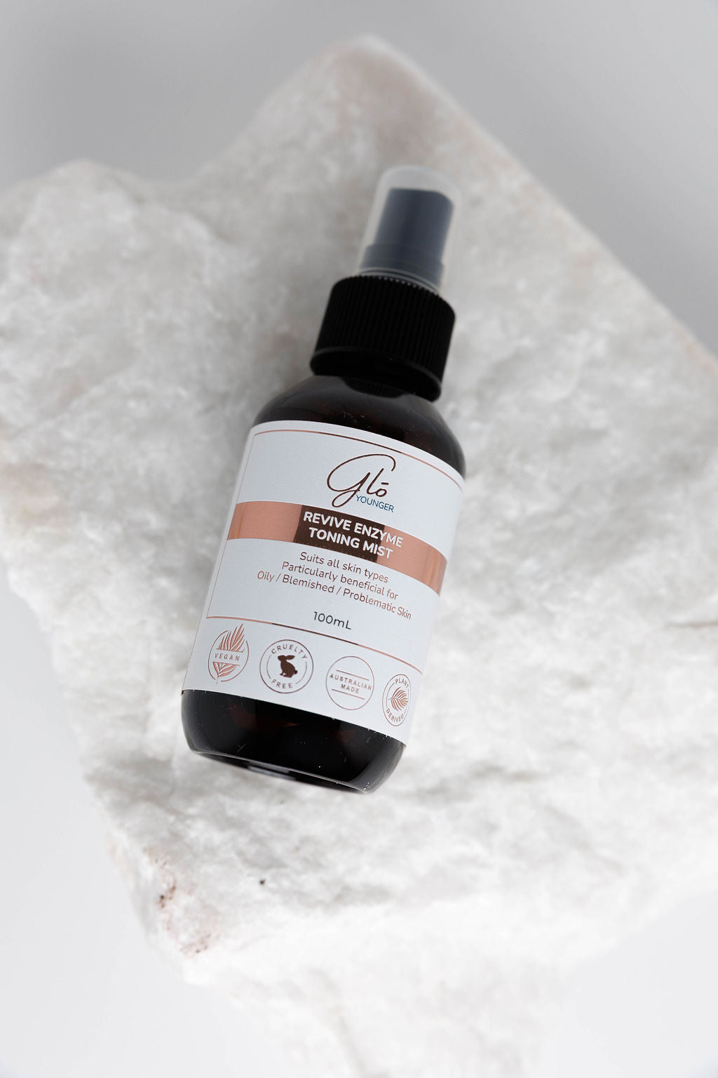 Glo Younger Revive Enzyme Toning Mist bottle on stone