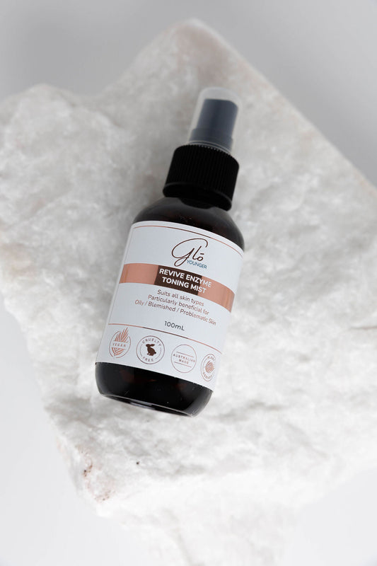 Glo Younger Revive Enzyme Toning Mist bottle on stone