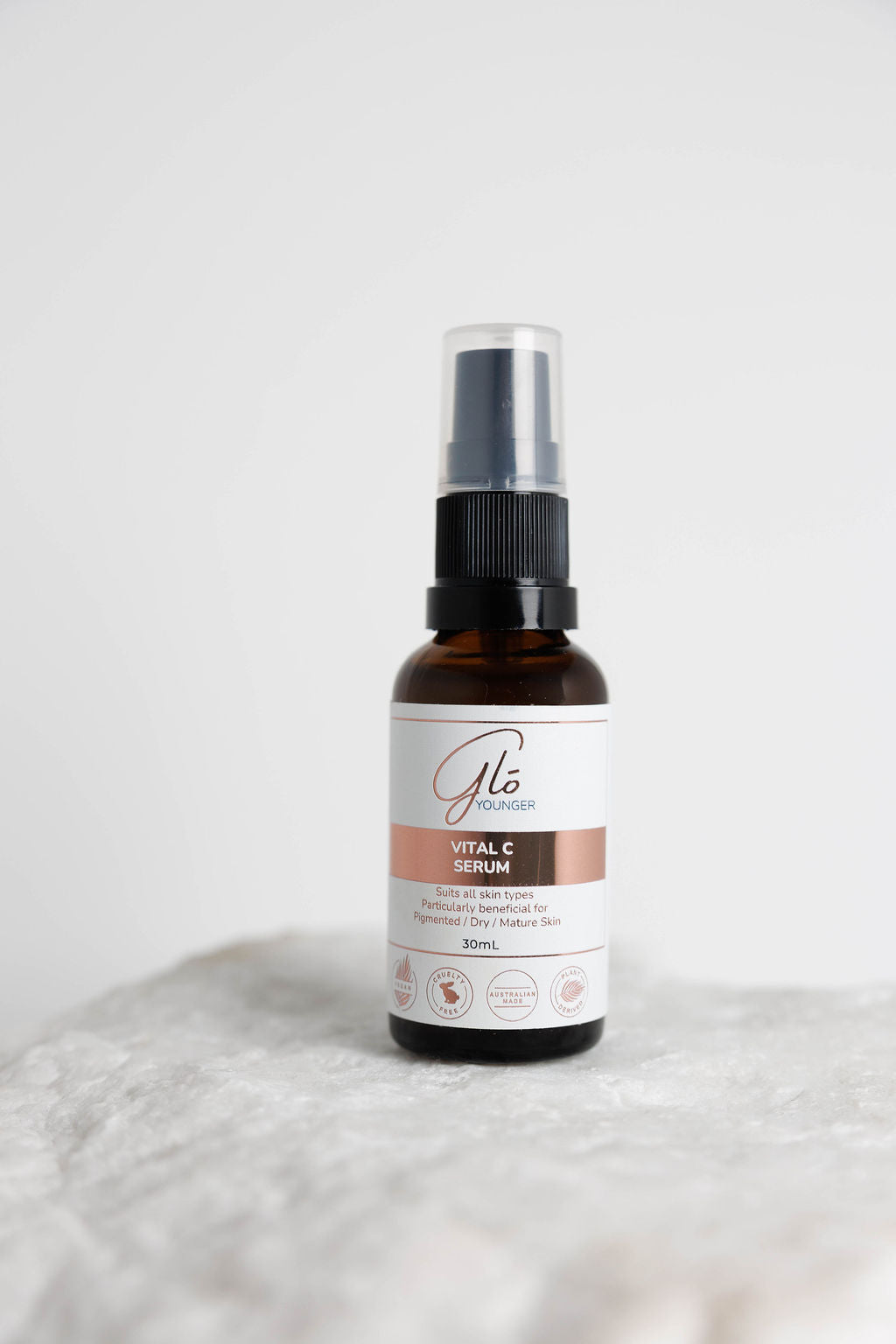 Glo Younger Vital C Serum bottle on stone