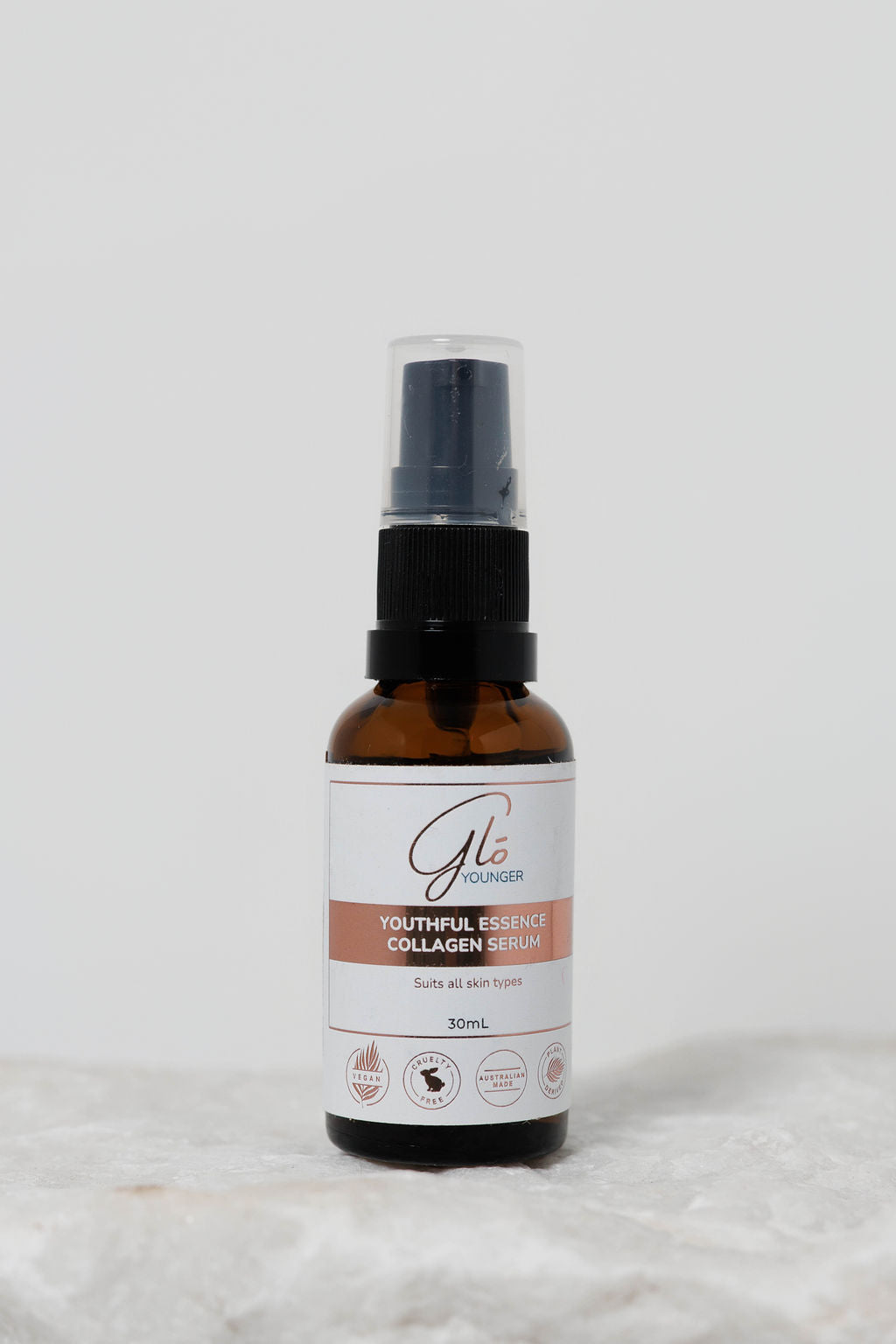 Glo Younger Youthful Essence Collagen Serum bottle on stone